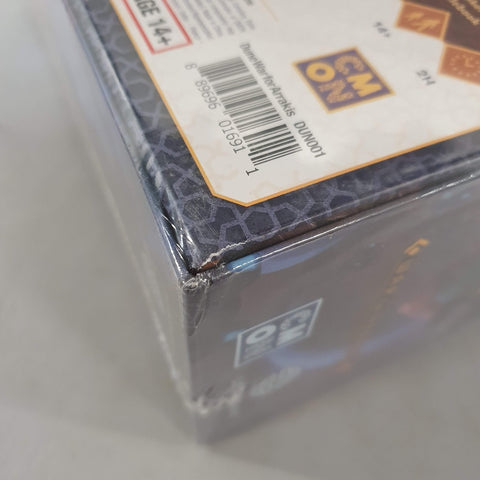 A close-up of the Dune: War for Arrakis (Damaged) box by Cool Mini Or Not, featuring dented corners, barcode, and age rating—perfect for any House Atreides or Spice collector.