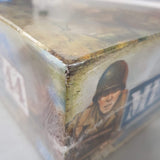 Close-up of a box with a soldier illustration and text, showing signs of wear.