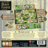 Back of the Black Forest by Feuerland Spiele showing game setup with boards, cards, tokens, player mats, resource wheels, rulebooks, game description, publisher info, and designer Uwe Rosenberg's photo.