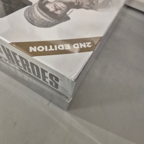 A close-up of a shrink-wrapped Company of Heroes: 2nd Edition (Damaged) board game by Bad Crow Games, showing a corner dent and "2ND EDITION" label—ideal for WWII wargame fans.