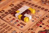 A close-up of Garphill Games' "Ezra and Nehemiah" board game shows white, yellow, and brown cubes on a grid with symbols and tracks inspired by the rebuilding of Jerusalem after Cyrus the Great’s decree.