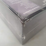 Close-up of a damaged HEXplore It: The Domain of Mirza Noctis box by Mariucci J. Designs, shrink-wrapped with crumpled plastic. "VOLUME IV CONTENTS" is partially visible—a rare discounted game find.