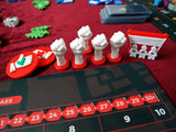 Four white fist-shaped tokens with red bases from Game Maker Team's Hegemony - 3D Upgraded Components are arranged on a red felt surface, alongside other game pieces and a visible score track.