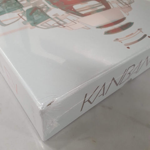 Close-up of a dented, plastic-wrapped Kanban EV (Damaged) box by Eagle-Gryphon Games, featuring stylized artwork of car parts and electric vehicles.