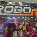 A close-up of a damaged Robo Rally (2023) box by Renegade Game Studios shows metallic lettering, robot miniatures, and detailed robot artwork, with a small fly perched on the letter O in "ROBOT.