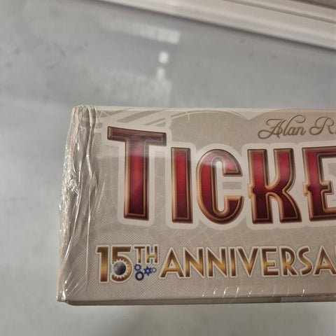 A close-up of a partially plastic-wrapped Ticket to Ride: Europe 15th Anniversary (Damaged) board game box by Days of Wonder, showing the "15th Anniversary" text and part of the word "Ticket" on the corner.