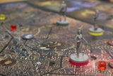 Close-up of the Teburu Game Platform Bundle by Pegasus Spiele in play, showing a detailed map, colored tokens, and three gray miniatures—one with a red base in sharp focus—set within Vampire: The Masquerade Milan Uprising.