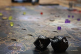 Two black twenty-sided dice rest on a vibrant board featuring "CORVETTO," with colorful pieces scattered across the Pegasus Spiele Teburu Game Platform Bundle—ideal for fans of Vampire: The Masquerade Milan Uprising.