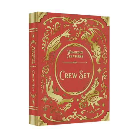 The Wondrous Creatures: Crew Set Expansion by Bad Comet is a red and gold hardcover book with ornate designs and illustrations of fantastical creatures, including a dragon and a bird, on the cover and spine.