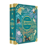 Wondrous Creatures by Bad Comet is a teal hardcover book with gold accents, showcasing whimsical illustrations of mythical animals, plants, fish, and faces for a magical, fantasy-inspired look.