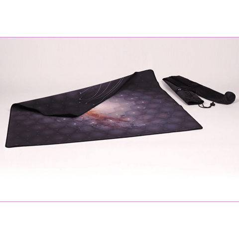 A Lautapelit Eclipse: Second Dawn for the Galaxy Playmat, featuring a cosmic design on dark neoprene, is partially unrolled on a white surface. Nearby is its carrying bag with shoulder strap and another playmat rolled up inside.